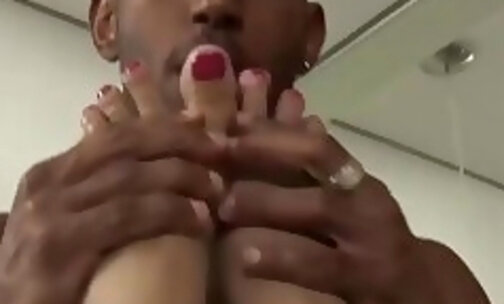Stunning blonde shemale with big tits gives a blowjob to her black lover