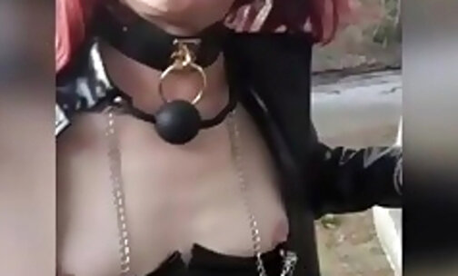 submissive sex caged gagged breast clamps, exhibited outdoors