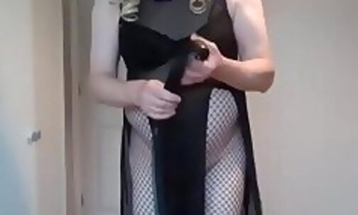 Dominatrix in black boots, see through outfit and whip