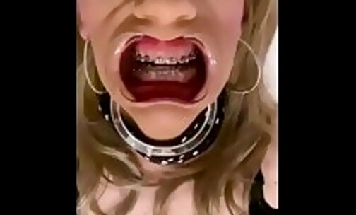Alexandra Braces is masturbating and dildo fucking while wearing an open mouth expander