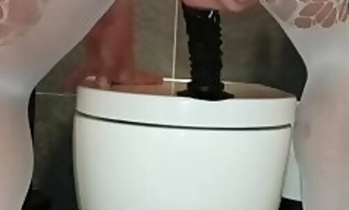 Horny dildo play at the toilet